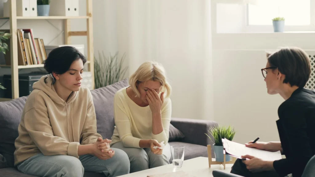 A family in an emotional therapy session indoors.