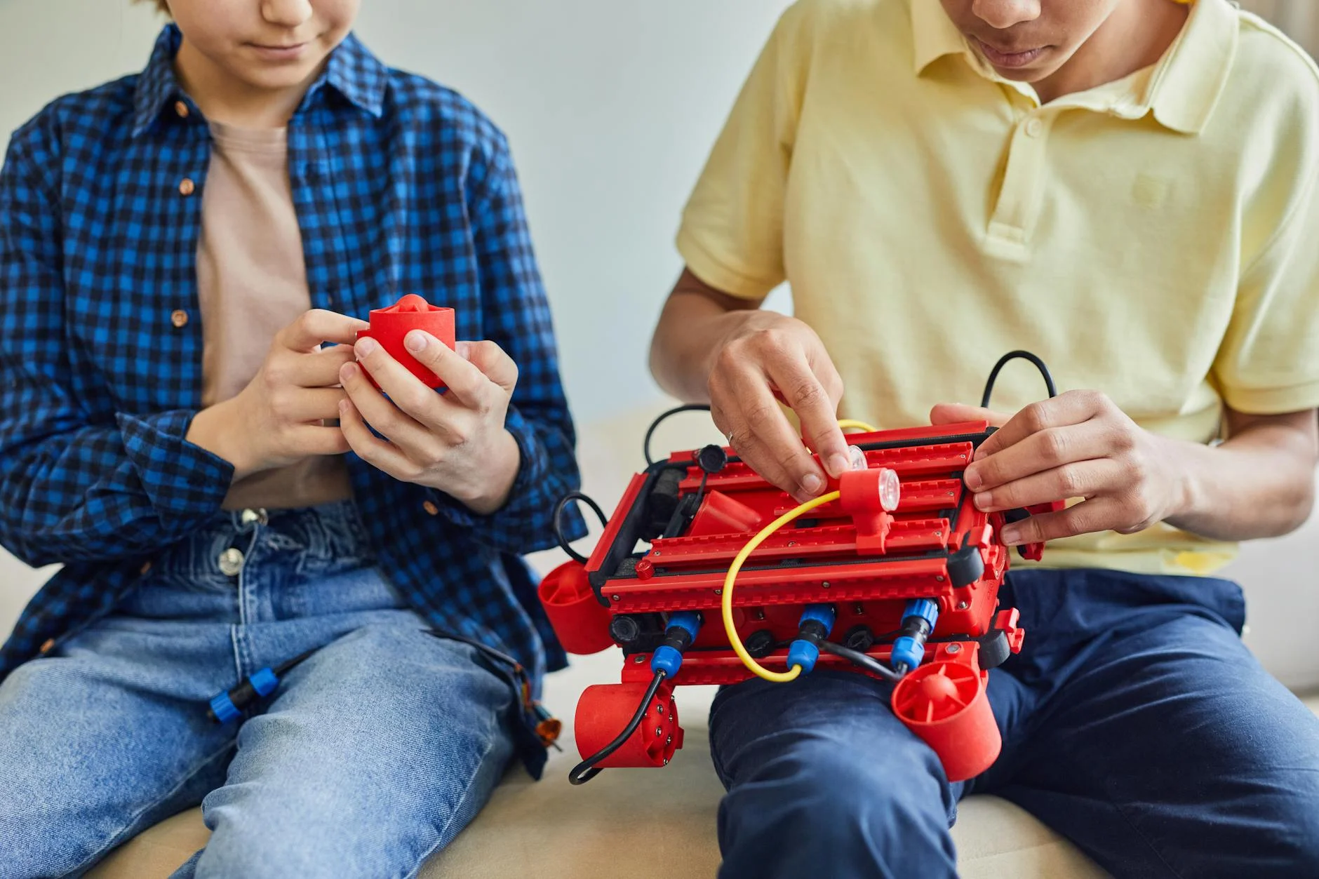 Two children assembling a robot, fostering teamwork and STEM learning.