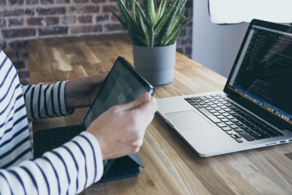woman with a tablet and a laptop